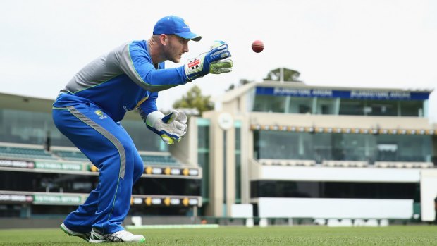 Venue fight: Australian wicketkeeper Peter Nevill takes the ball during an Australian nets session at Blundstone Arena.