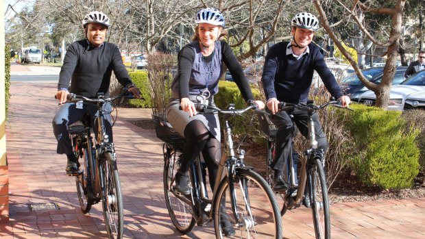 The trial of pedal-assisted electric bicycles, or e-bikes, is being rolled out across ACT government workplaces. Udaya Kumar, left, Nicola Plunkett-Cole and Richard Horton try them out.