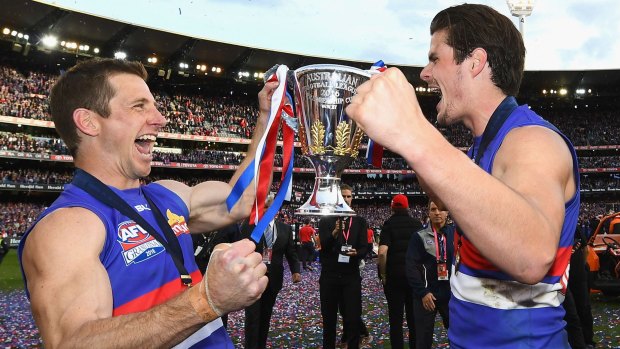 Dale Morris and Tom Boyd of the Bulldogs celebrate with the trophy.