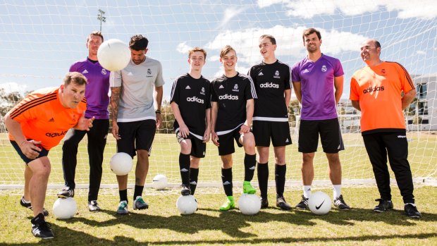 Real Madrid have academy coaches in Canberra running a clinic for the week. From left, Tuggeranong United coach Steve Kunovec, Santi Escudero, coach Peter Kofinas, Samuel Molloy, 15, Benjamin Carling, 15, Christopher Reay, 14, coach Pau Alberti and Luke Santiago. 
