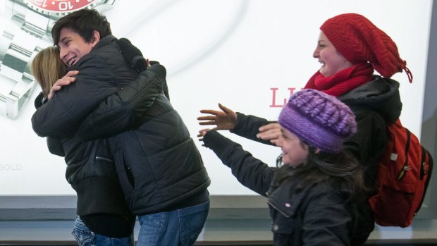 Shergo Kurdi hugs his aunt, Tima Kurdi, as his sisters, Ranim Kurdi, front right, and Haveen Kurdi, run to meet her as the family arrives in Vancouver.