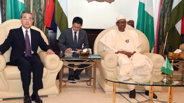 Chinese Foreign Minister, Wang Yi, left, and Nigeria President Muhammadu Buhari, right, sit during a meeting at the Presidential Villa in Abuja, Nigeria.
