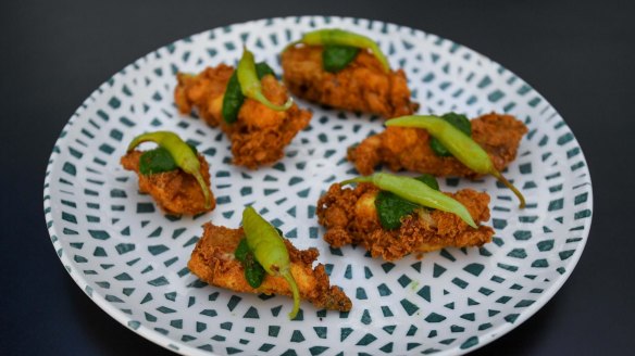 Deep-fried chicken ribs with chimichurri and guindilla peppers.