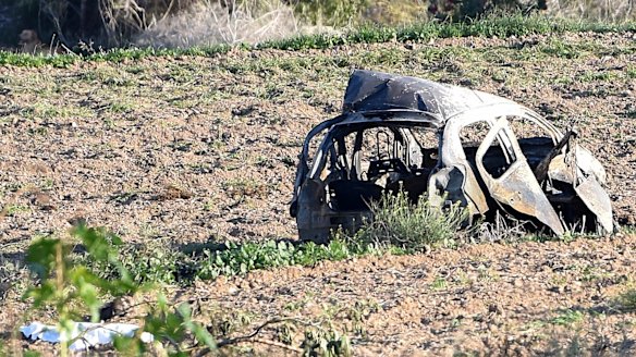 The wreckage of the car of investigative journalist Daphne Caruana Galizia lies next to a road in the town of Mosta, Malta.