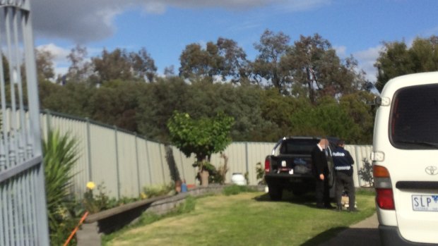 An AFP officer at the raided house.