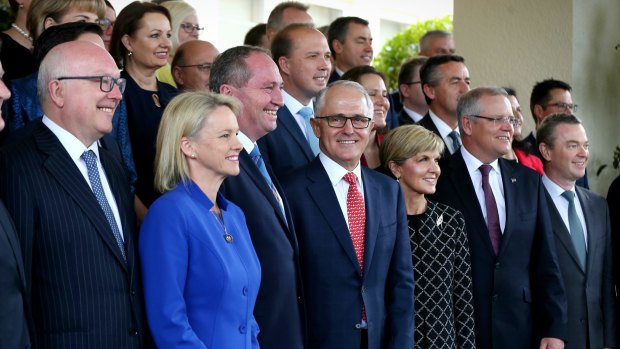 Prime Minister Malcolm Turnbull poses for photos with his ministry after the swearing-in ceremony on Tuesday.