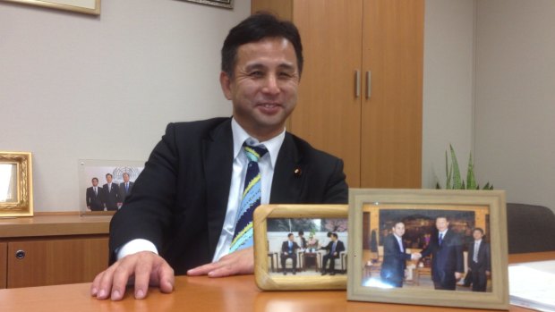 Mending fences: Kiyohiko Toyama at his office in Tokyo, with framed pictures of his meetings with Chinese President Xi Jinping and Vice-President Li Yuanchao.