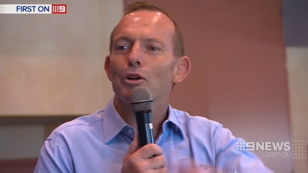 Tony Abbott struggles to conceal a grin as his supporters boo Malcolm Turnbull's name at a rally at Balgowlah RSL.