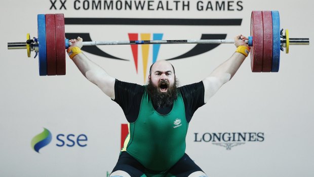 Weight of expectation: Damon Kelly wins bronze at the Glasgow Commonwealth Games.