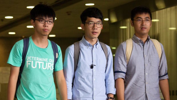 Three Hong Kong student protest leaders, from left, Joshua Wong, Nathan Law and Alex Chow walk out from a magistrate's court in Hong Kong, last year.