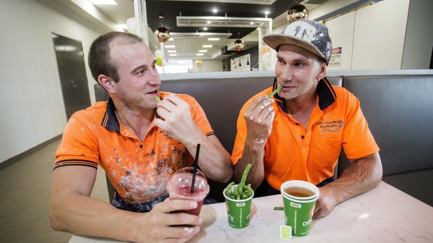 Construction workers Jeremy Krojs (left) and Darryl Piotrowski eating green beans and drinking a smoothie and green tea at Oliver's Real Food in Port Melbourne.