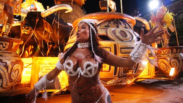 A dancer performs near a float of the Imperio Serrano samba school parade at the carnival in Rio.