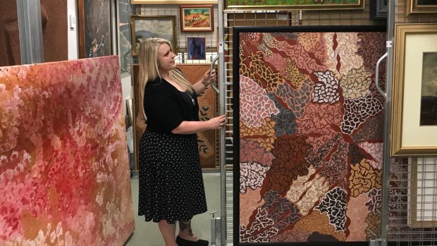 Tara Callaghan, director of the Broken Hill regional gallery, with some of the collection in storage.