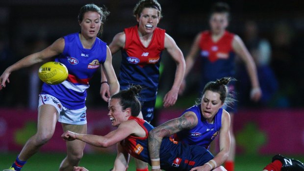 Daisy Pearce gets a handball away under pressure at Whitten Oval