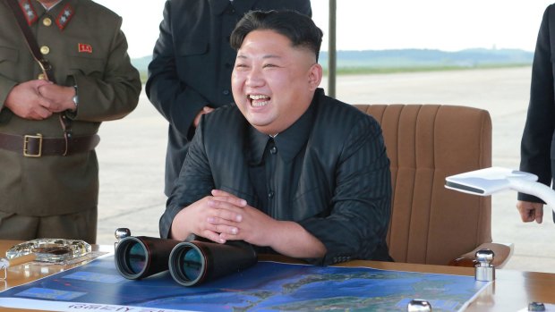 In this undated file photo distributed by the North Korean government, Kim Jong-un attends what was said to be the test launch of an intermediate range Hwasong-12 missile.