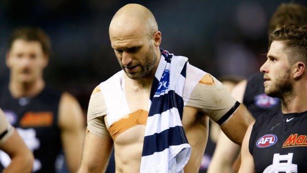 Now the walk off: Chris Judd leaves the field with his unexpected souvenir.