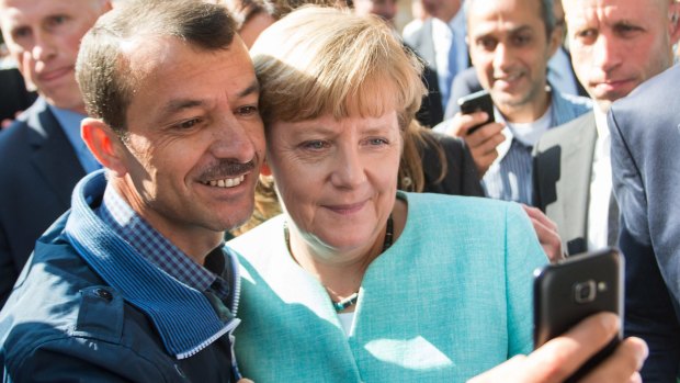 German Chancellor Angela Merkel has pictures taken with refugees at a reception centre for asylum seekers in Berlin.