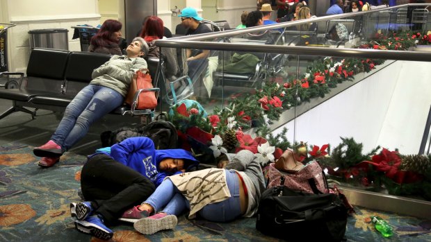 Passengers sleep in Terminal 4 after the airport reopened at 5 am  at Fort Lauderdale.