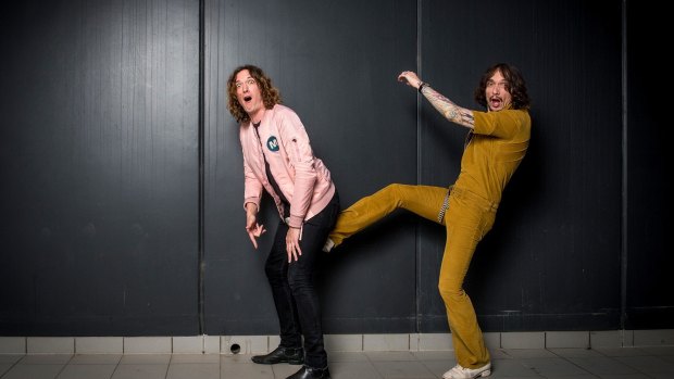 Justin Hawkins, lead singer and guitarist of British rock band The Darkness, with his brother Dan Hawkins.