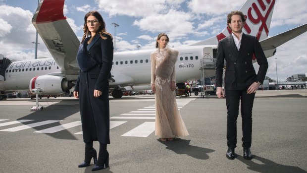 Camilla Freeman-Topper (left) and Marc Freeman (right) with a model in one of their designs ahead of the Grand Showcase at the Melbourne Fashion Festival on Thursday night.