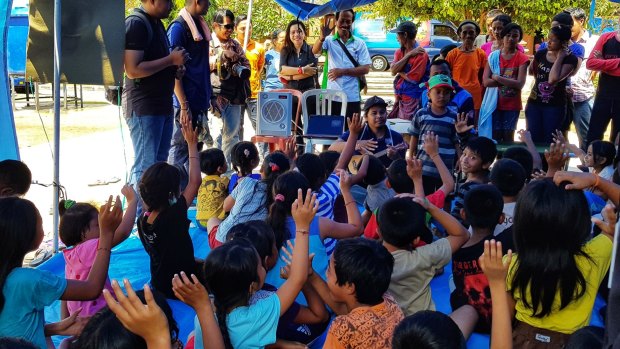 Children participate in activities at the Swecapura sports centre in Klungkung, Bali, while they wait for news on Mount Agung.