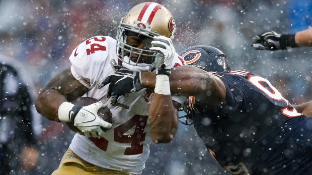 Chicago's Akiem Hicks (right) tackles the 49ers' Shaun Draughn in the snow, and this weekend, it's going to freeze.
