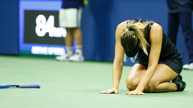 Overwhelmed: Maria Sharapova drops to the court after winning match point.