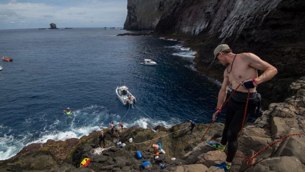 Rock climber Zane Privbbenow pulls up supplies. Photo: Wolter Peeters