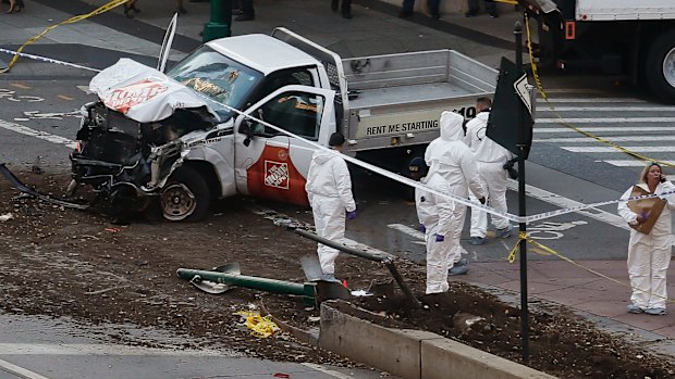 Authorities stand near a damaged Home Depot truck after its driver mowed several people down in New York on Tuesday.