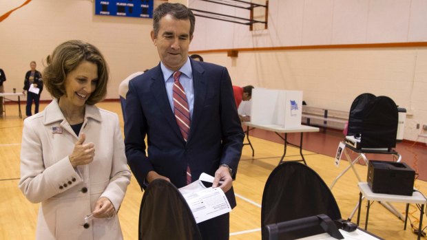 Ralph Northam, and his wife, Pam, approach the vote tally machine in Norfolk, Virginia.