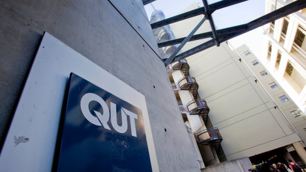 A Queensland University Technology administration officer is now facing having to pay costs of up to six figures to three students.