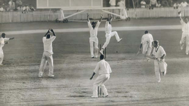 Flashback to 1960: Lindsay Kline (right) glances back to see Ian Meckiff being run out by a direct hit from Joe Solomon to tie the first Test between Australia and the West Indies at the Gabba.