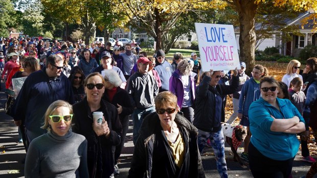 Hundreds of women, girls and other supporters proudly donned their yoga pants as they peacefully paraded around the Rhode Island neighbourhood of a man who derided the attire as tacky and ridiculous. 
