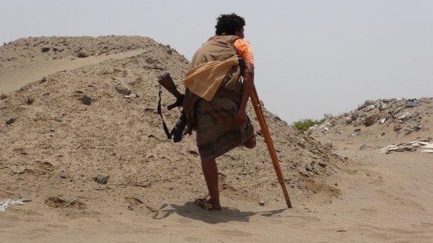 An anti-Houthi fighter of the Southern Movement with an amputated leg stands at the front line near the southern port of Aden.