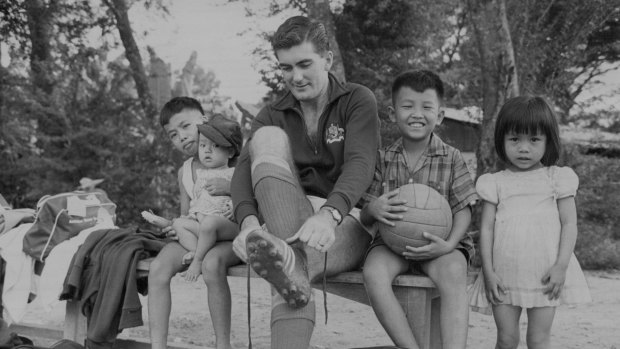 Gary Wilkins laces his boots before a training session in Saigon in 1967.