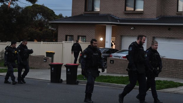 Riot squad police leave the Greenacre home after arresting a 24-year-old man on Thursday.