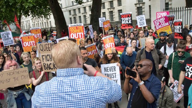 Protesters outside Downing Street in London call on the PM to resign.