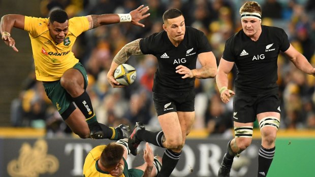 Through the gap: Sonny Bill Williams steps through the tackle of Sean McMahon.