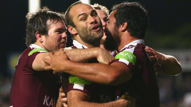 Surging up the table: Manly's Jamie Lyon, Brett Stewart and Daly Cherry-Evans  celebrate with Peter Hiku after he scored.