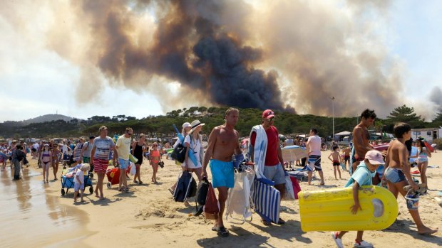 Sunbathers are being evacuated from the beach in Le Lavandou, on the French Riviera.