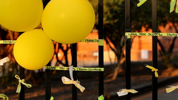 Messages written on ribbons at the floral tribute in front of Leeton High School where Stephanie Scott worked.