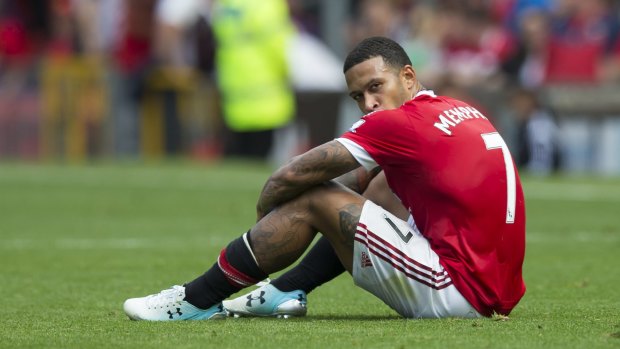 Unhappy: Manchester United's Memphis Depay sits on the pitch after his team's scoreless draw in the English Premier League match against Newcastle at Old Trafford.