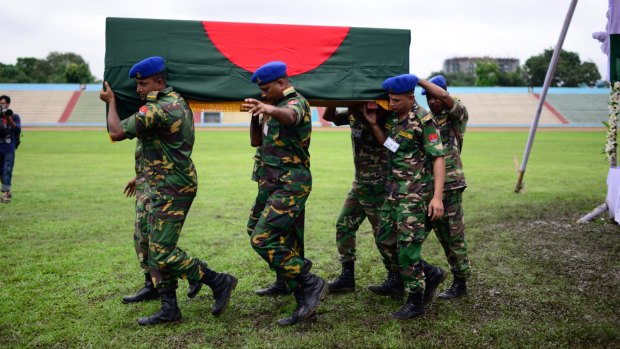 Soldiers carry the coffin of a victim of the restaurant massacre at a memorial ceremony in Dhaka.