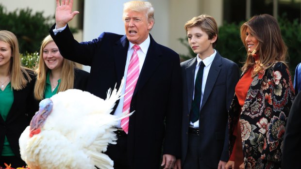 Trump with first lady Melania Trump and their son Barron Trump at Thanksgiving Day festivities. 