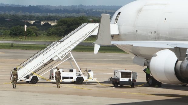 Zimbabwean aviation authorities impounded a US-registered cargo jet after a dead body later believed to be a stowaway and millions of South African rand were found on board, a senior official said Monday. 