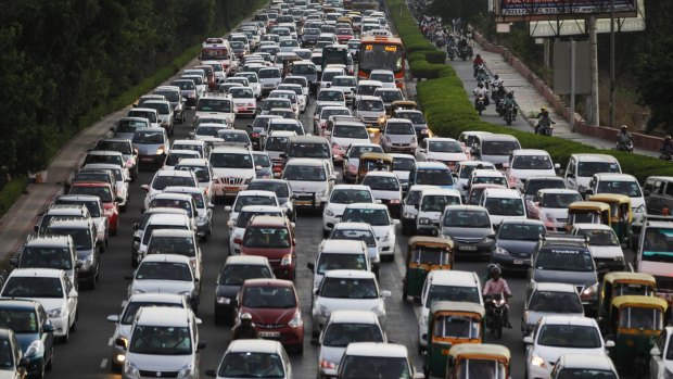 Traffic moves slowly at dusk in New Delhi.