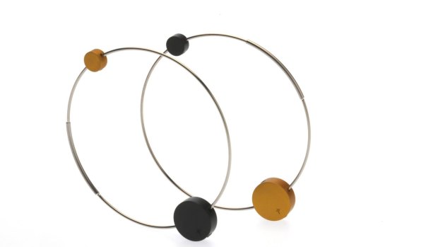 Disc earrings by Phoebe Porter made from yellow and black aluminium and stainless steel.