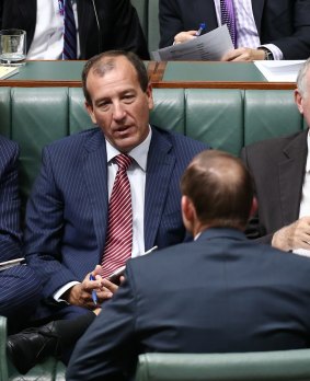 Mal Brough and Prime Minister Tony Abbott speak during a division of Parliament last year.