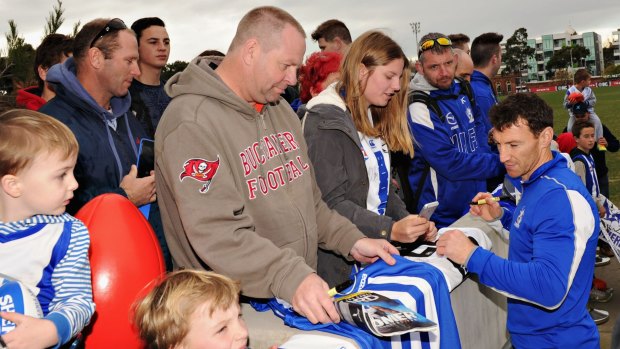 Popular: Brent Harvey signs autographs after training on Friday.