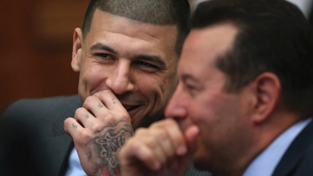 Aaron Hernandez laughs with defence attorney Jose Baez during a hearing.